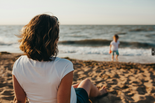 Person enjoying sunlight outdoors, highlighting the importance of Vitamin D for hormone support